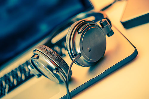Headphones on Laptop Computer. Online Music Listening. Music Concept.
